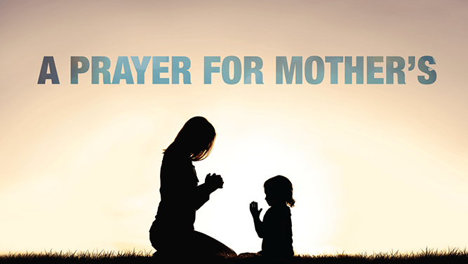 Image of woman praying with child